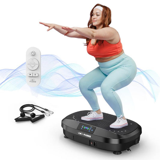 A person using a vibration plate fitness machine while performing a squat with a remote control nearby.
